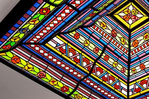 a close up of a stained glass ceiling at Main Street Hotel in Ypres