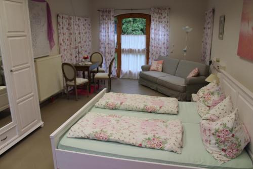 a living room with two beds and a couch at Reiterbauernhof Schönlehenhof in Mank