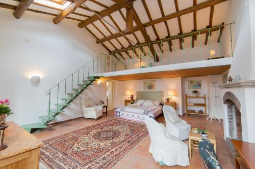 a large room with a bed and a staircase at Frascati Country House in Grottaferrata
