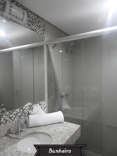 a bathroom with a sink and a glass shower at Sonia Flats 214 - Flat privado no Apart Hotel Pipa's Bay in Pipa