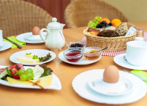 a table with plates of food and eggs on it at Ferienapartments Schnibbe in Bad Lauterberg