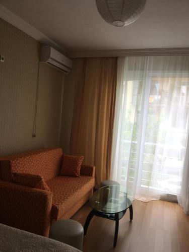 a living room with a couch and a glass table at Irma Apartment in Batumi