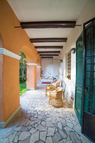 a patio with a table and chairs and a building at Frascati Country House in Grottaferrata