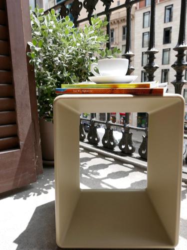 a white table with a bowl on top of it at DestinationBCN - Universitat Rooms in Barcelona