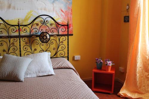 a bedroom with a bed with a large headboard at La Barcarola in Tavernola Bergamasca