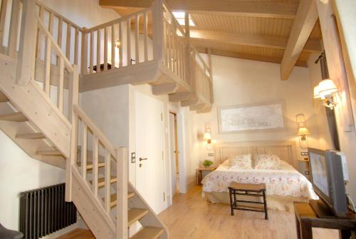 a bedroom with a bed and a staircase at Hotel Plaza in Castejón de Sos