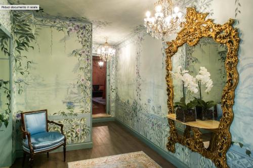 a room with a mirror and a chair at Casa Borsari Suite in Verona