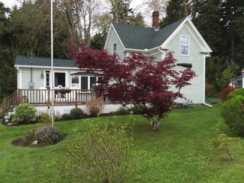 a white house with a porch and a deck at Newagen Seaside Inn in Southport