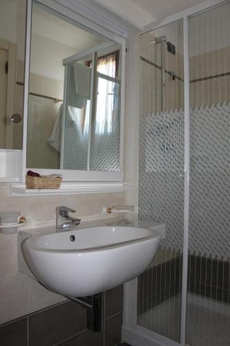 a bathroom with a white sink and a shower at Hotel Girasole in Civitanova Marche