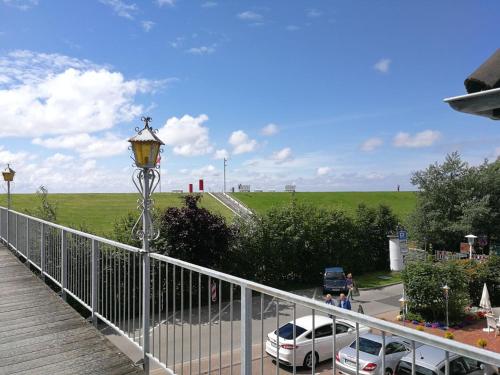 a balcony with a street light next to a parking lot at Strandhotel Salty in Büsum
