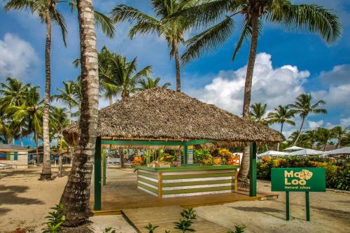 a kiosk on the beach with palm trees at Catalonia Royal La Romana Adults Only - All Inclusive in Bayahibe