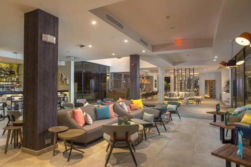 a lobby with couches and chairs and tables at Catalonia Royal La Romana Adults Only - All Inclusive in Bayahibe
