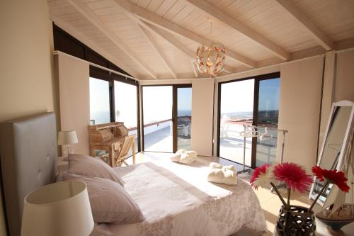 a bedroom with a bed with a view of the ocean at Loft Sunset View, Costa Adeje in Adeje