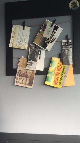 a bunch of books are hanging on a wall at Nomada Urban Beach Hostel- Calle Loiza in San Juan