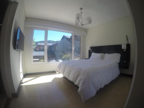 Llit o llits en una habitació de Departamento Malbec