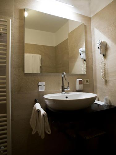a bathroom with a sink and a mirror at Hotel Engel in Canazei