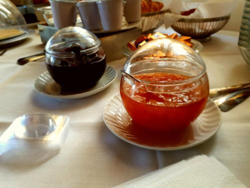 a table with two plates of food and a drink at Agriturismo Antico Borgo Poggitazzi in Loro Ciuffenna