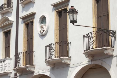 a street light on the side of a building with balconies at Hotel Casa Del Pellegrino in Padova