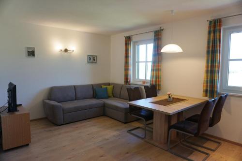 a living room with a couch and a table at Ferienwohnung Hausleitner in Zell am Moos