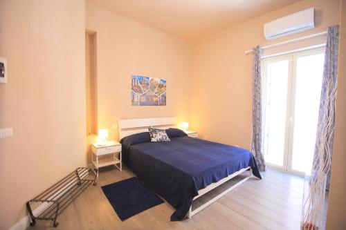 a bedroom with a bed and a large window at Gioeni ventidue in Agrigento