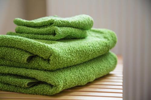 a stack of green towels sitting on a table at Qi Gong Haus in Roßdorf