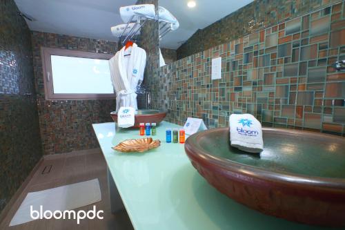 a bathroom with a wooden tub and a sink at Bloom! exclusive boutique b&b in Playa del Carmen