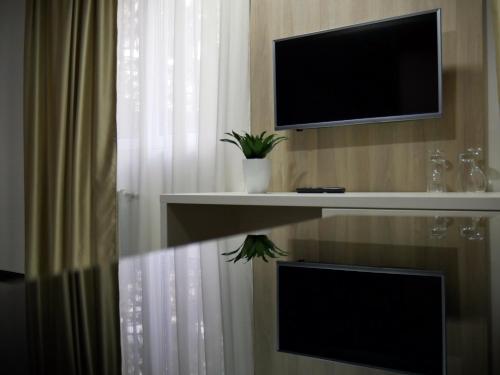 a room with a flat screen tv and a curtain at Hotel Berane in Berane
