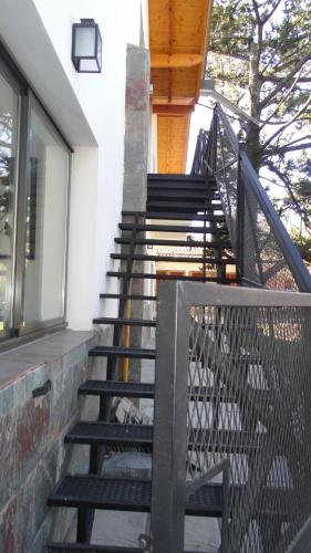 a set of stairs leading up to a building at Posada Ojo de Agua Villa General Belgrano in Villa General Belgrano