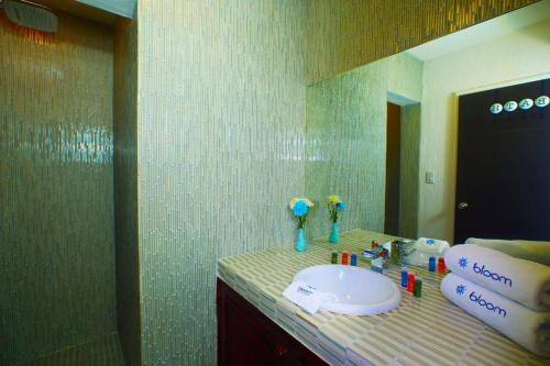 a bathroom with a sink and a mirror at Bloom! exclusive boutique b&b in Playa del Carmen
