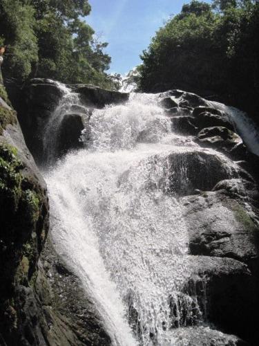 a waterfall on the side of a rocky river at La Cima del Mundo in Chimirol