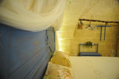 a small room with a bed and a wall at Palazzo Savoia 1856 in Fasano