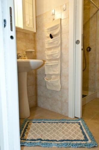 a bathroom with a sink and a shower with towels at Antica Masseria Adamo in Sampieri