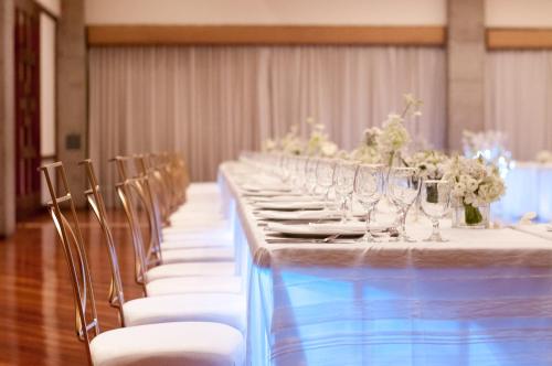 a long table with chairs and wine glasses at Radisson San Jose-Costa Rica in San José