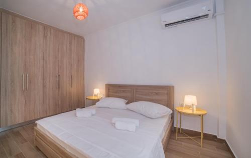 a bedroom with a large bed with two night stands at Zante Deco Apartment in Zakynthos Town