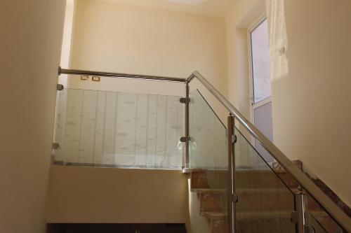 eine Treppe mit einem Glasgeländer in einem Gebäude in der Unterkunft The Place Apartments in Amman