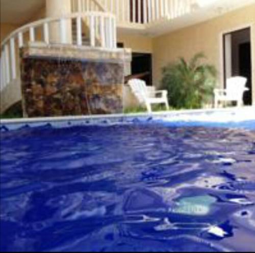 a large swimming pool with a blue water at QUINTA DIAMANTE villas&hotel in Barra Vieja