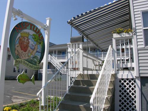 a sign on the side of a building with stairs at Neptune Motel Maine in Old Orchard Beach
