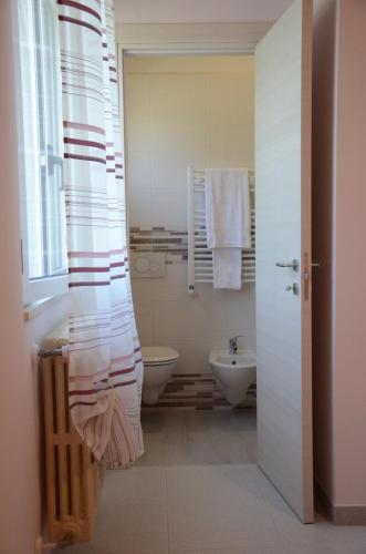 a bathroom with a tub and a toilet and a sink at La Collinetta Dei Sassi in Matera