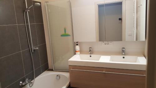 a bathroom with two sinks and a shower and a toilet at Mainstreet Knokke in Knokke-Heist