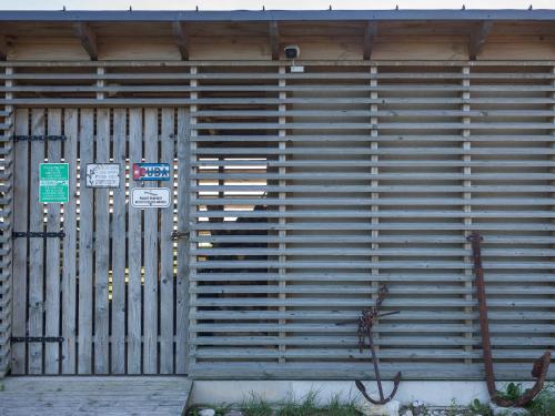 a large wooden garage door with a gate at Harbor House Lõmala in Lõmala