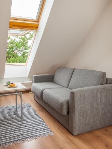 a living room with a couch and a table at Harbor House Lõmala in Lõmala