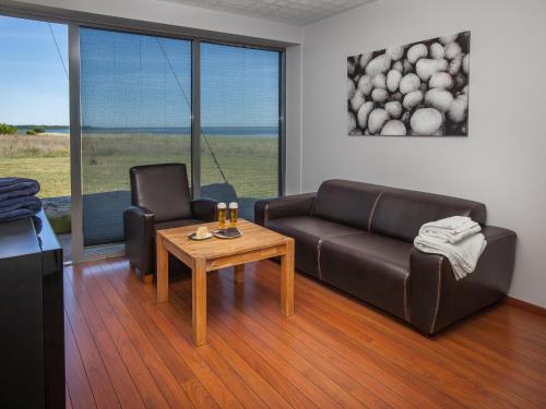 a living room with a couch and a table at Harbor House Lõmala in Lõmala
