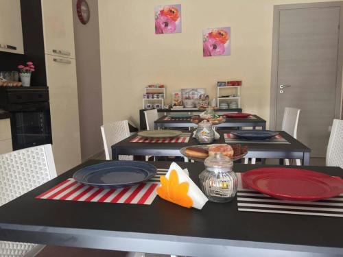 a dining room table with red and blue plates at Marianè in Favara