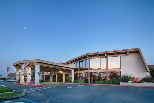 a building with a parking lot in front of it at Red Lion Hotel Redding in Redding