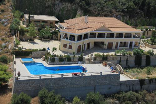 an aerial view of a house with a swimming pool at Villa Akros and Suites in Keri