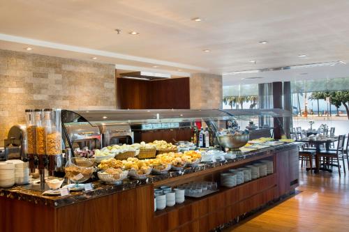 a buffet line with food on display in a restaurant at Windsor Leme Hotel in Rio de Janeiro