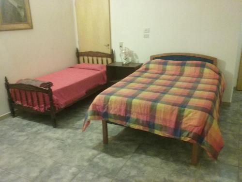 1 dormitorio con 2 camas y una falda en Alojamiento Dell Acqua en Santa Rosa de Calamuchita