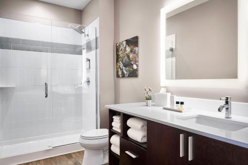 a bathroom with a shower and a toilet and a sink at The Abernathy in Clemson