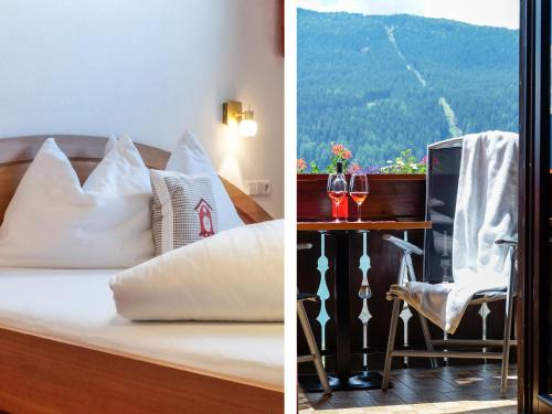 a hotel room with a bed and a table with wine glasses at Pension Apartment Erna in Resia
