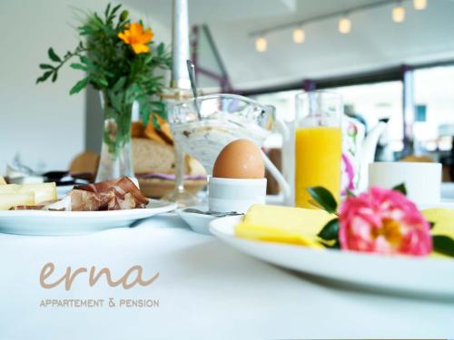 a table with plates of food and eggs and cheese at Pension Apartment Erna in Resia